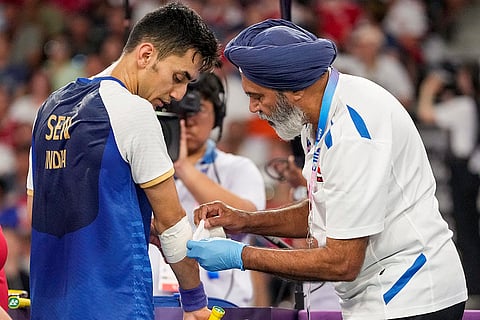 Lakshya Sen being given medical assistance during his men's singles bronze medal badminton match